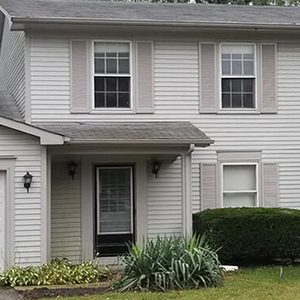 After house washing photo of front of a white house