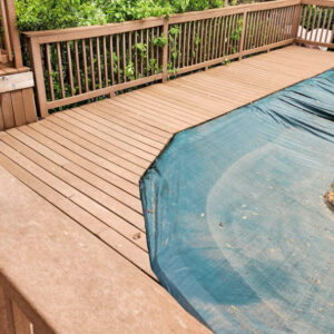 Photo of a deck around a covered pool after being cleaned