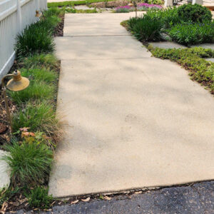 Photo of a concrete walkway after being power washed