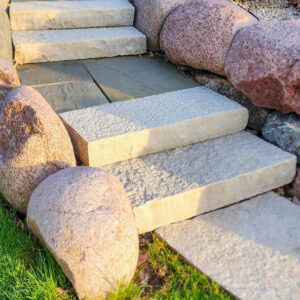 Photo of stone steps and boulders after being power washed
