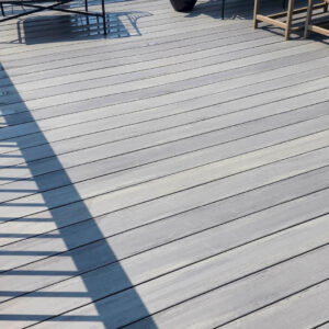 Photo of a gray deck with patio furniture after being cleaned